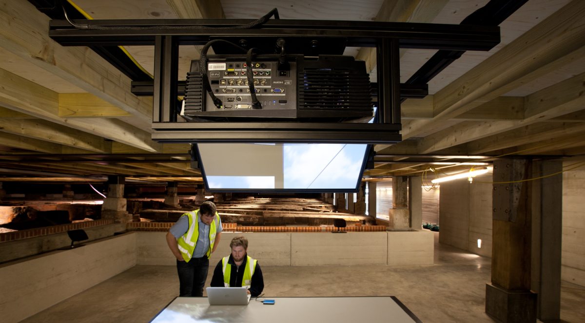 two men working on a laptop on an installation